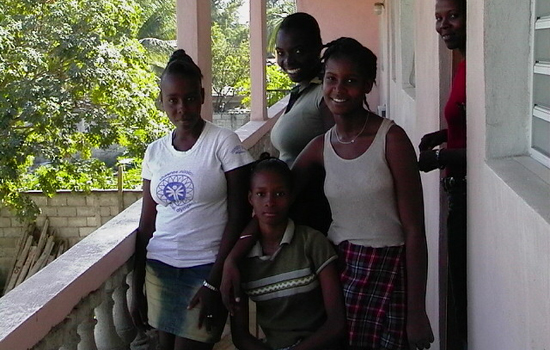 Ginette has her calluses removed by her friends on the balcony of Detente Tropicale Hotel.