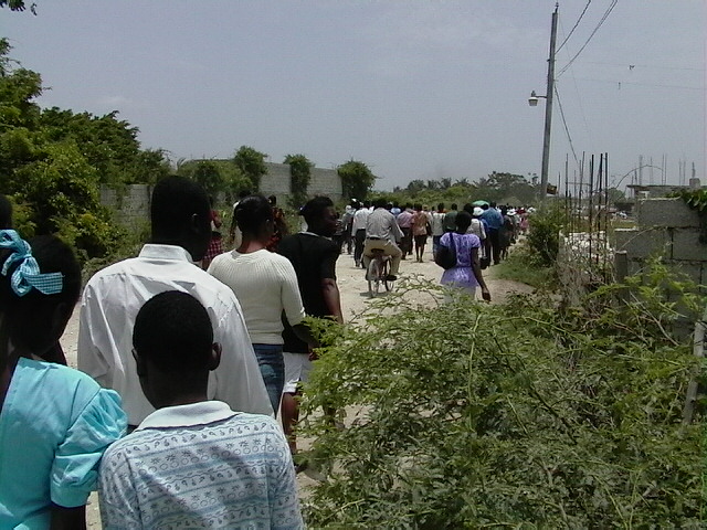 Walking down a dirt road to the church.