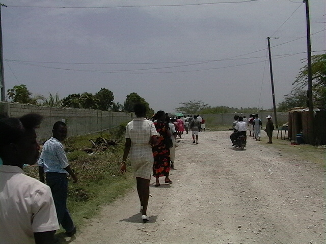 Walking down a dirt road to the church.