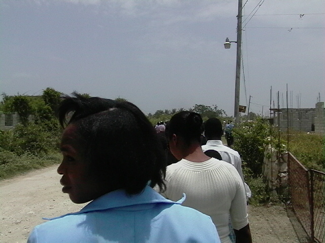 Walking down a dirt road to the church.